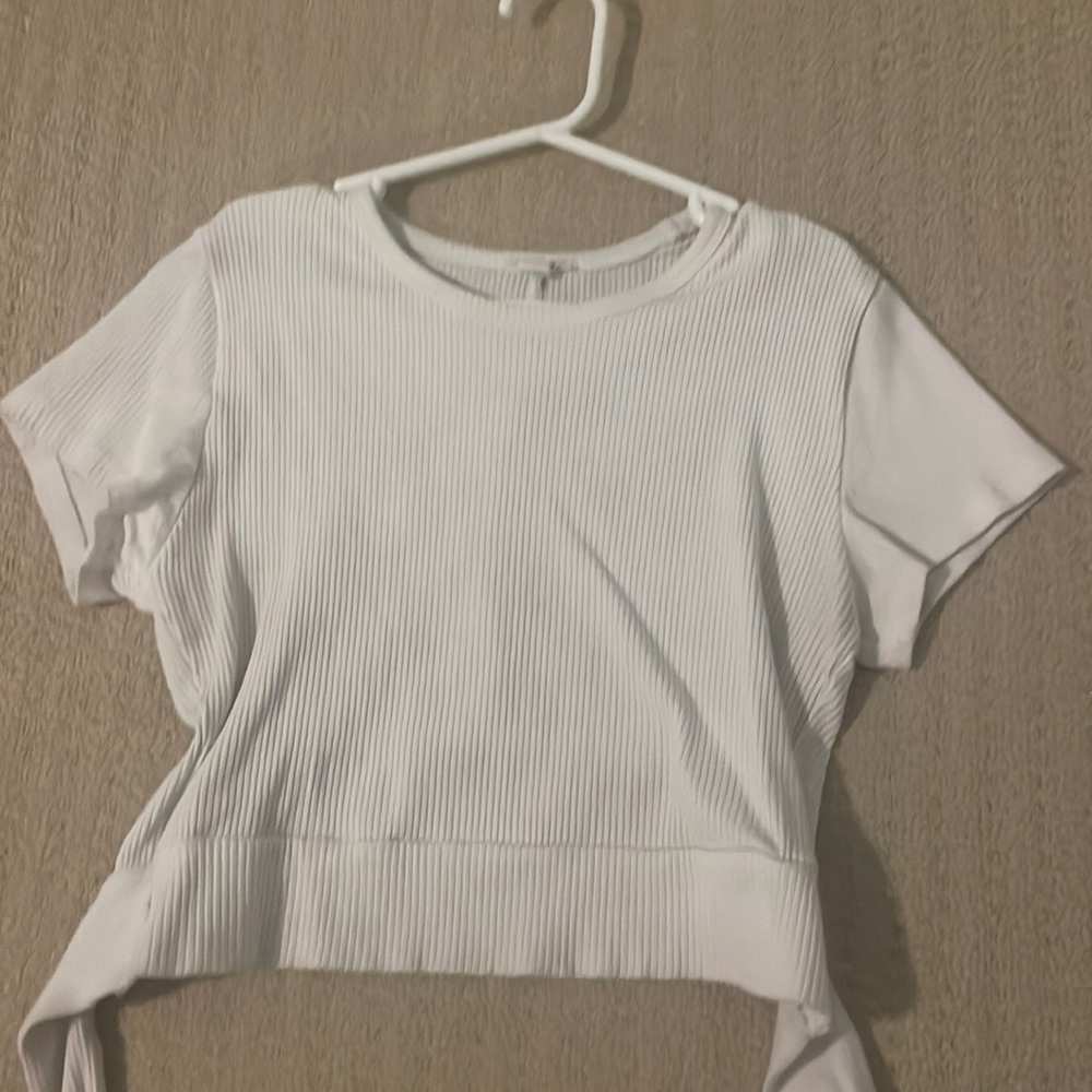 White cropped garage tee with open back. Never word and size medium